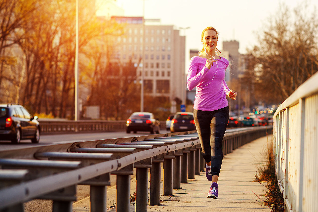 Woman jogging along a road.